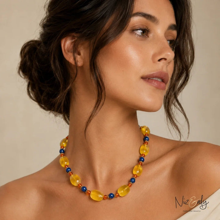 Niz & Aly beaded necklace featuring yellow agate, carnelian, and lapis lazuli gemstones worn by a woman.