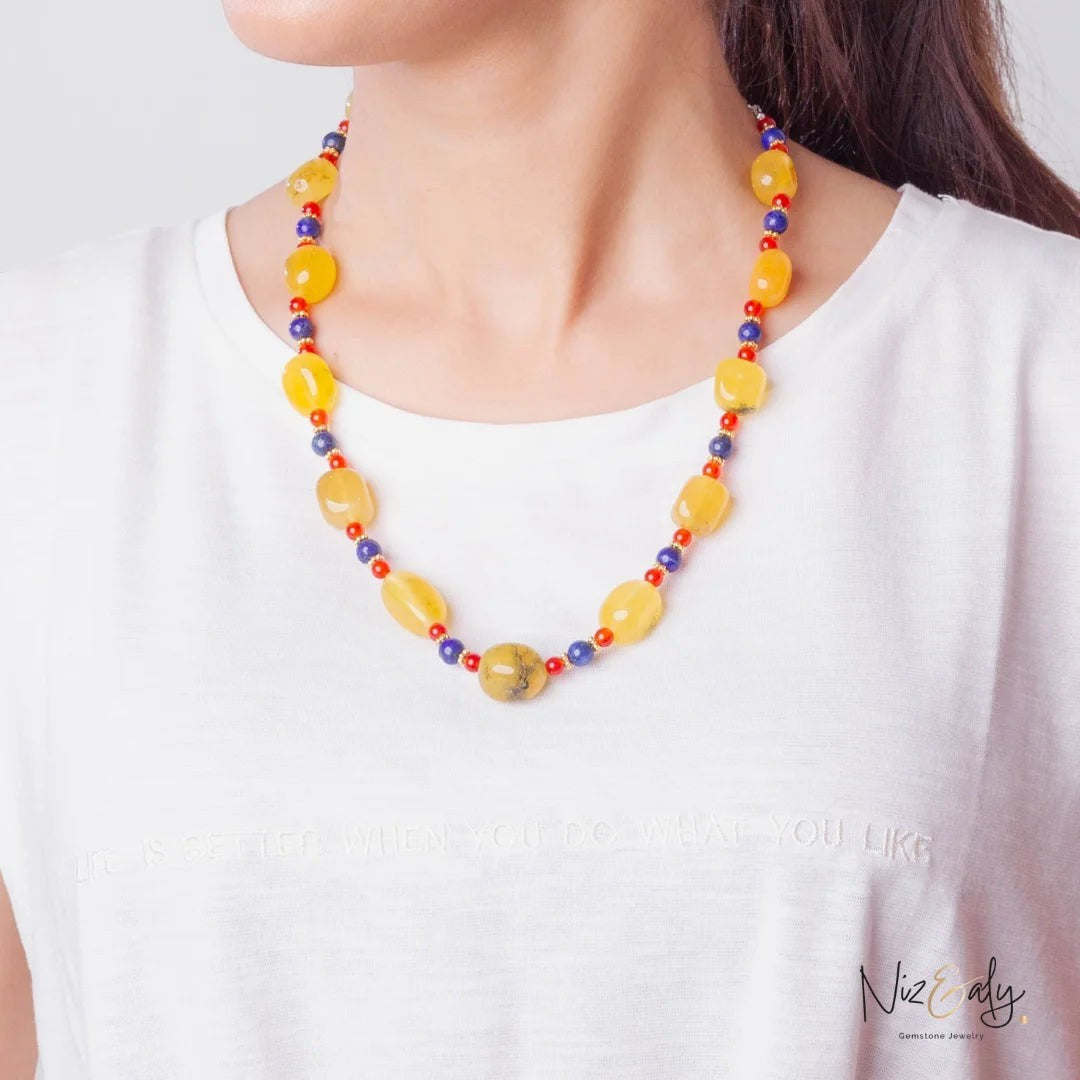 Niz & Aly multicolor beaded necklace featuring yellow agate, carnelian, and lapis lazuli gemstones on a model