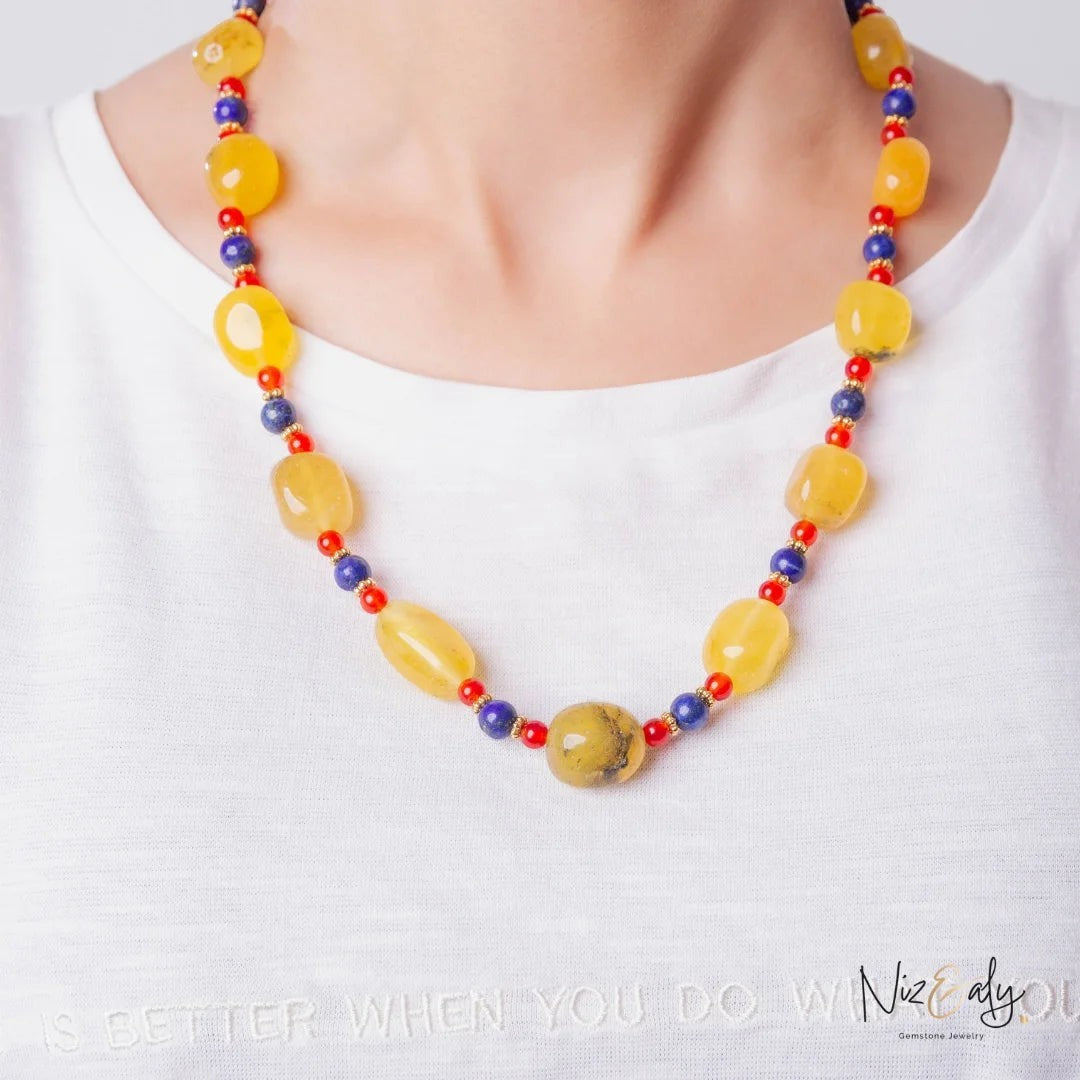 Niz & Aly multicolor beaded necklace featuring yellow agate, carnelian, and lapis lazuli gemstones on a model.