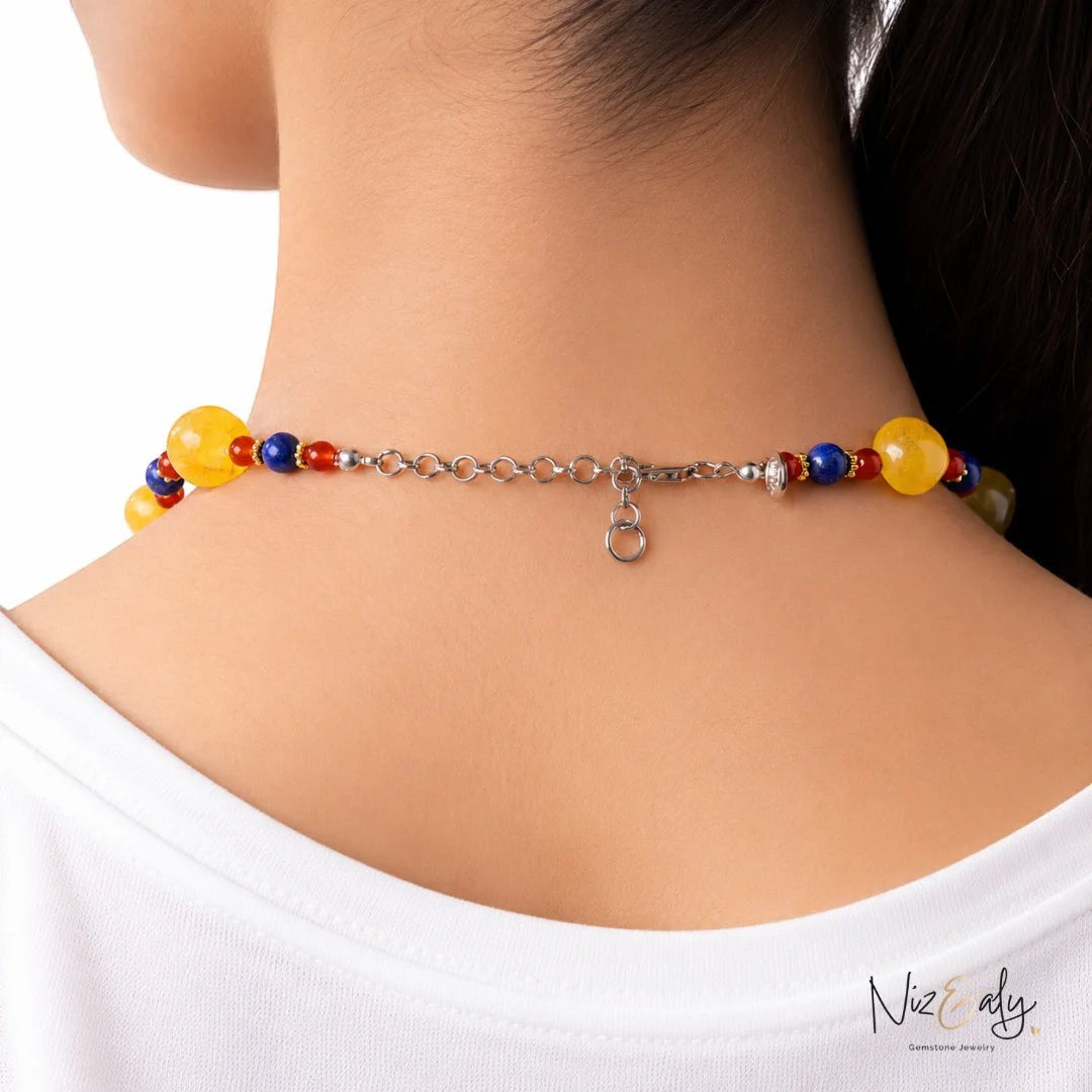 Niz & Aly multicolor beaded necklace featuring yellow agate, carnelian, and lapis lazuli stones on a silver extension chain.