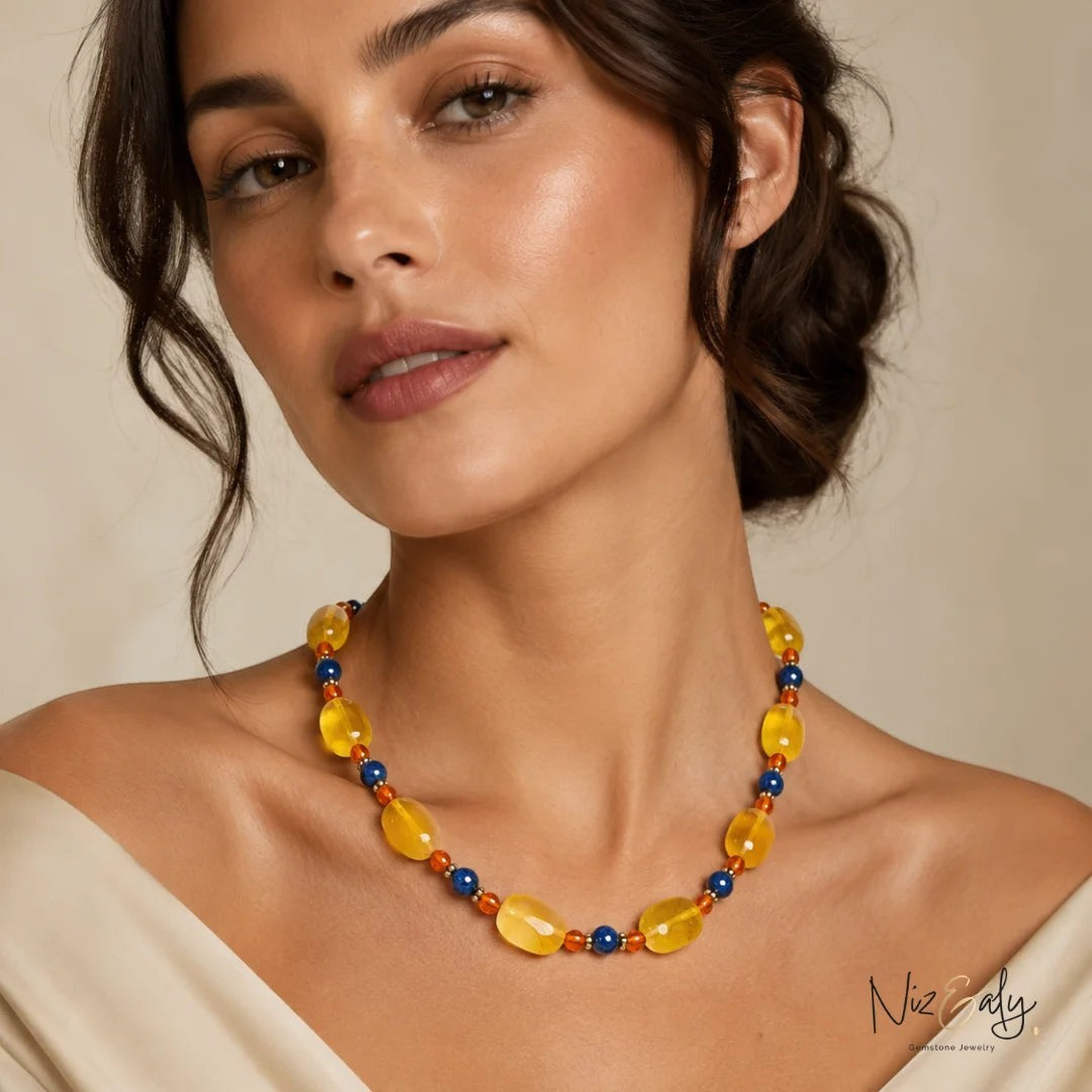 Niz & Aly necklace featuring yellow agate, carnelian, and lapis lazuli beads worn by a woman.