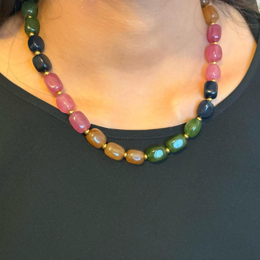 Niz & Aly multicolored rectangular jade-quartz gemstone necklace worn on a model with a black top.