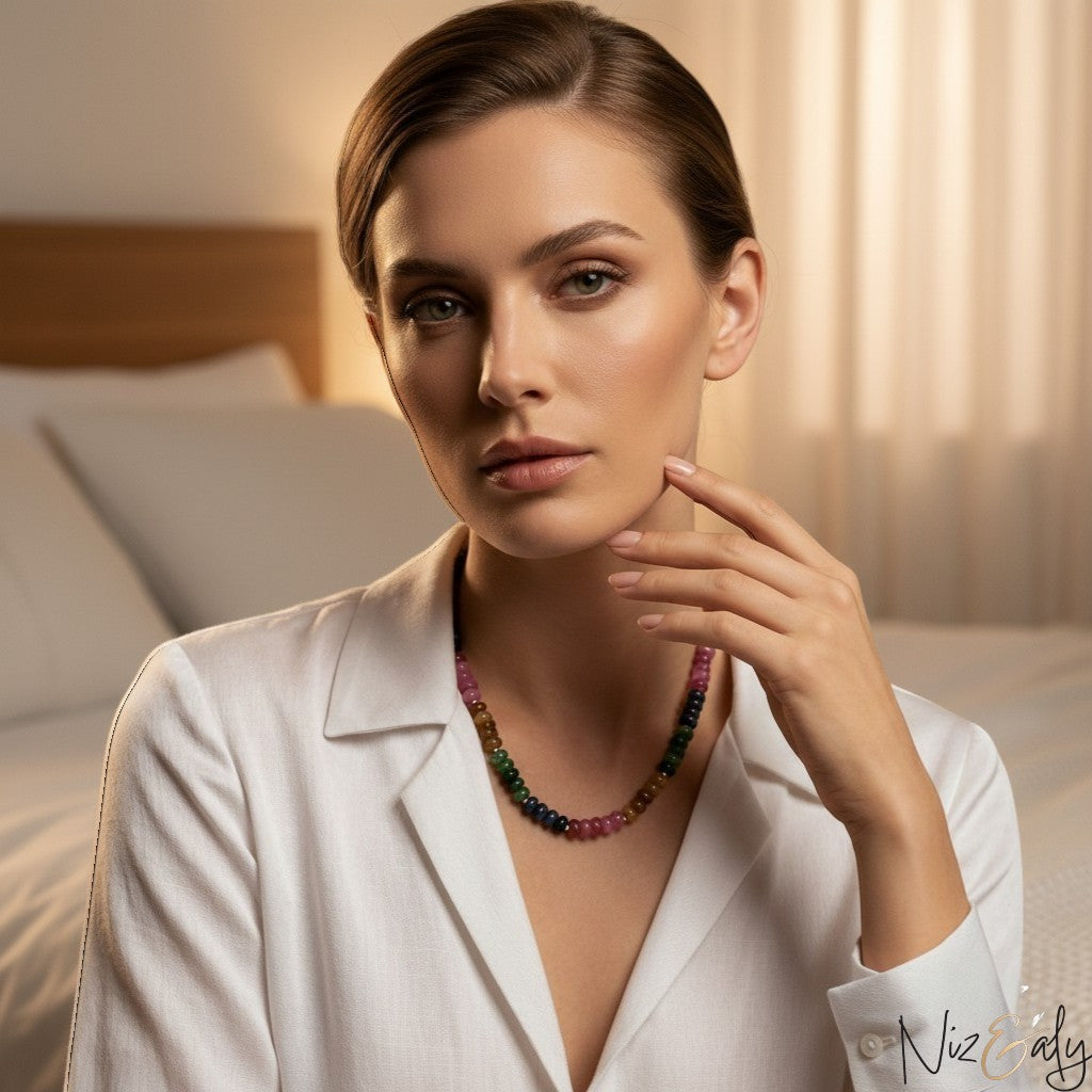 Niz & Aly multicolored oval jade quartz necklace worn by a woman in a white shirt in a soft bedroom setting.
