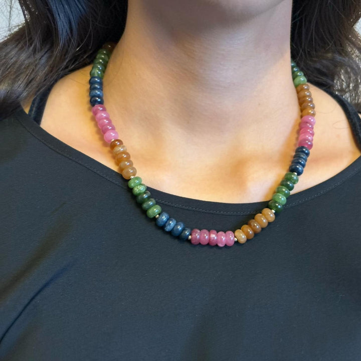 Niz & Aly multicolored oval jade and quartz gemstone necklace worn on a person with a black top