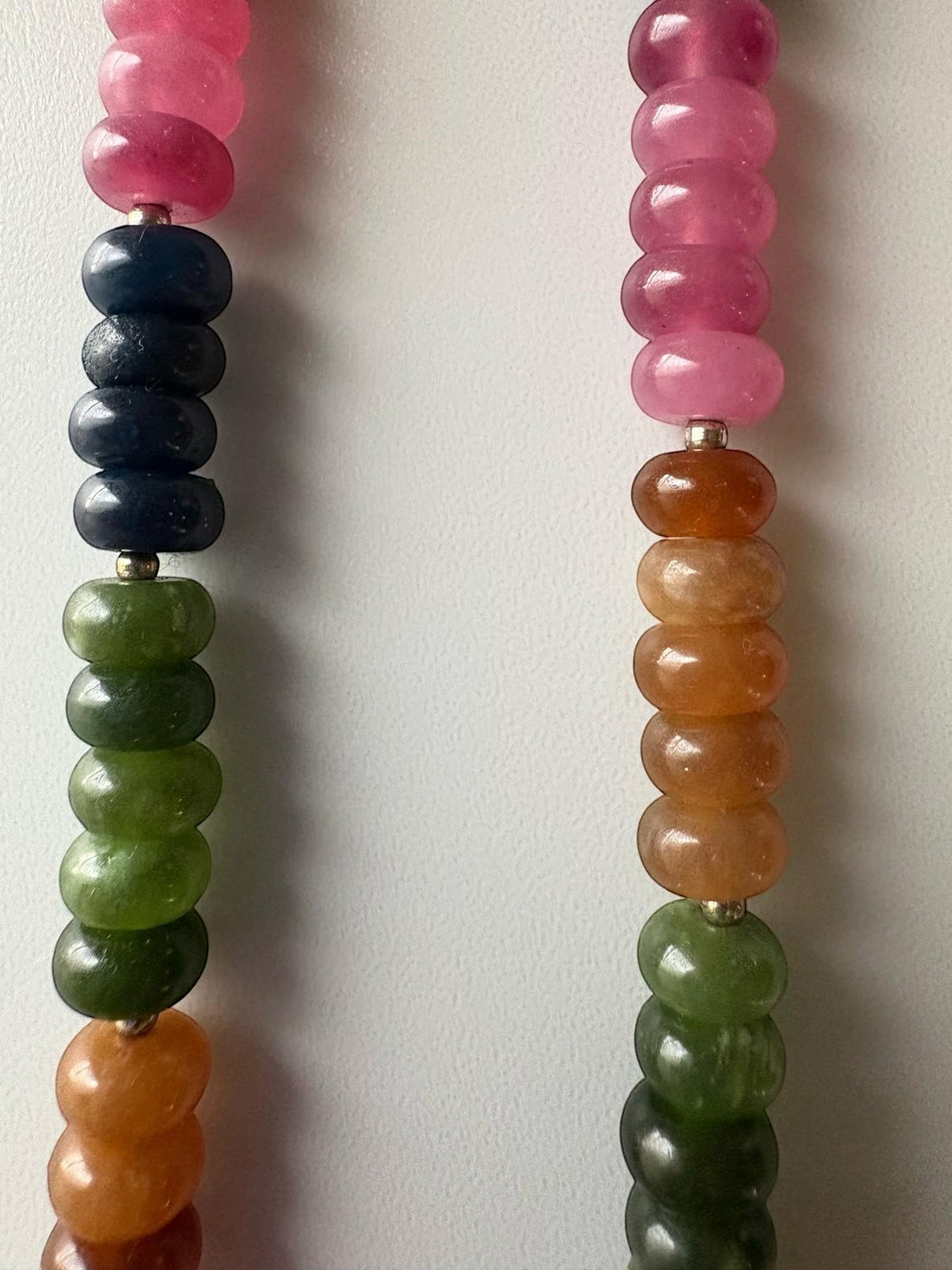 Niz & Aly multicolored oval jade and quartz gemstone necklace with smooth, polished beads in various vibrant hues.