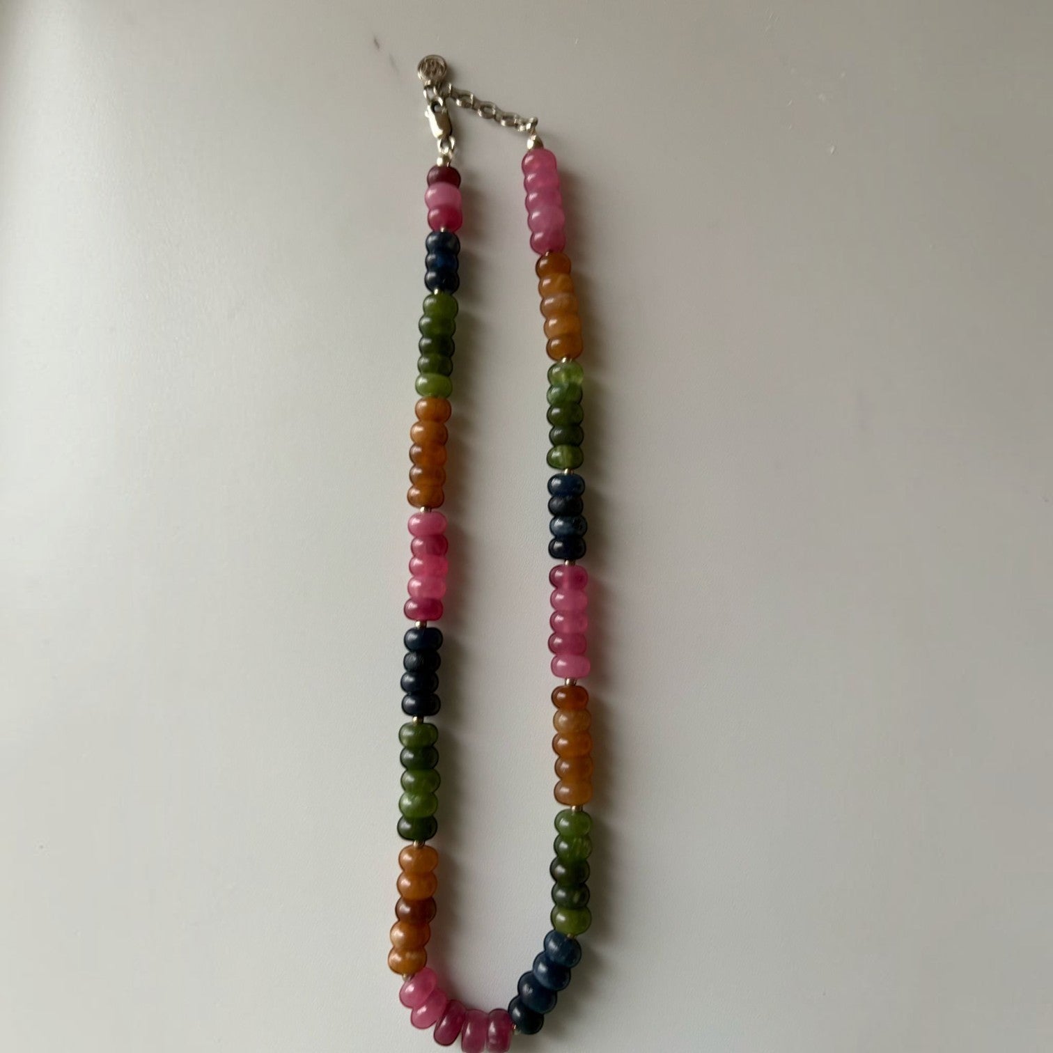 Niz & Aly multicolored quartz bead necklace with smooth oval stones in pink, green, blue, and gold on a silver chain.