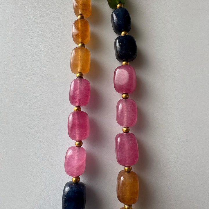 Niz & Aly multicolored rectangular quartz gemstone necklace with gold spacer beads on a white background.
