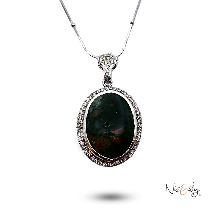 Niz & Aly natural bloodstone pendant with red flecks in a silver frame surrounded by sparkling white crystals