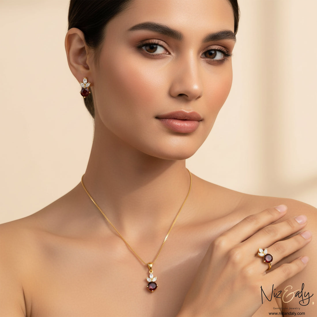 Niz & Aly natural garnet jewelry set featuring a gold necklace, matching earrings, and ring with floral accents.