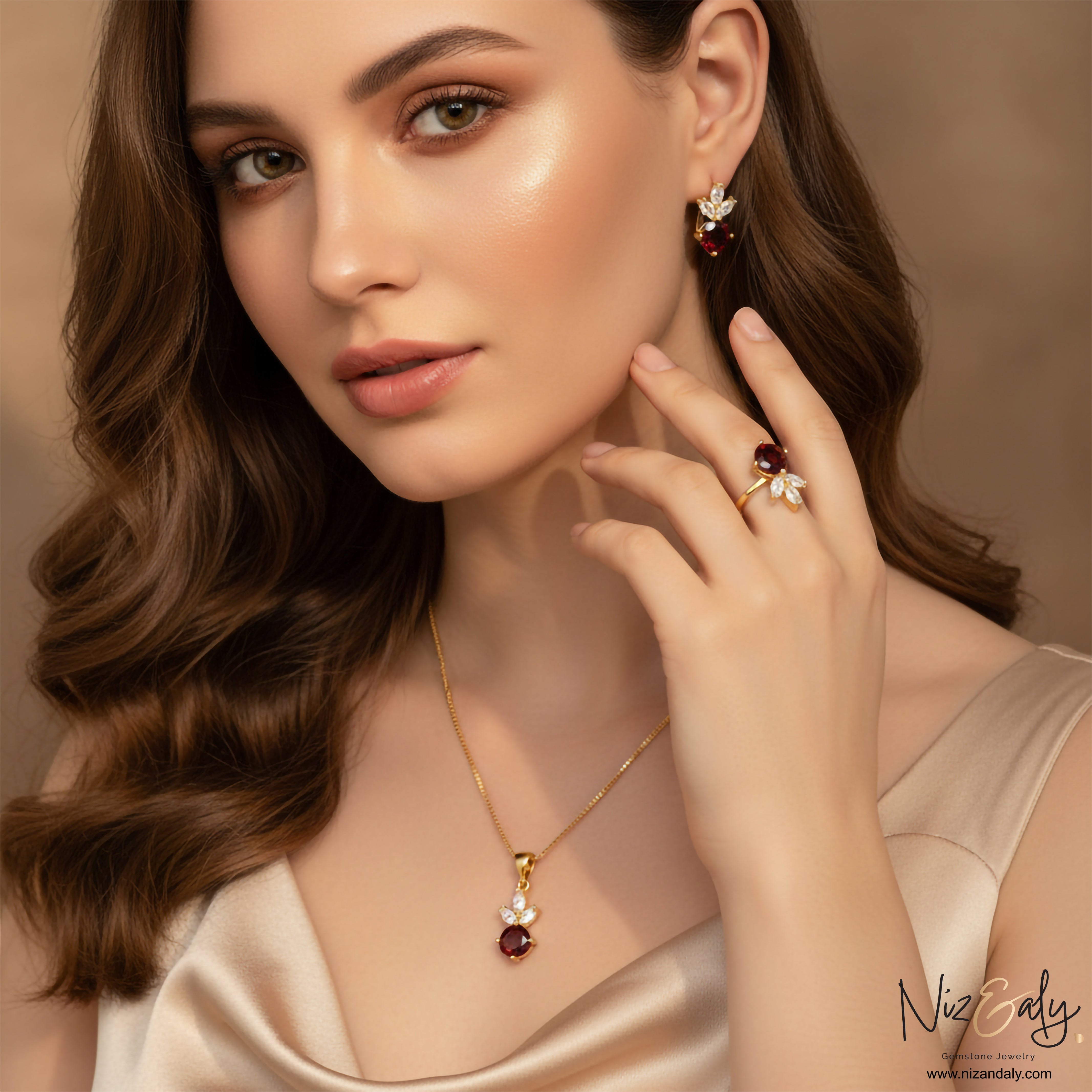 Niz & Aly natural garnet jewelry set featuring a gold necklace, ring, and earrings with leaf-shaped crystal accents.