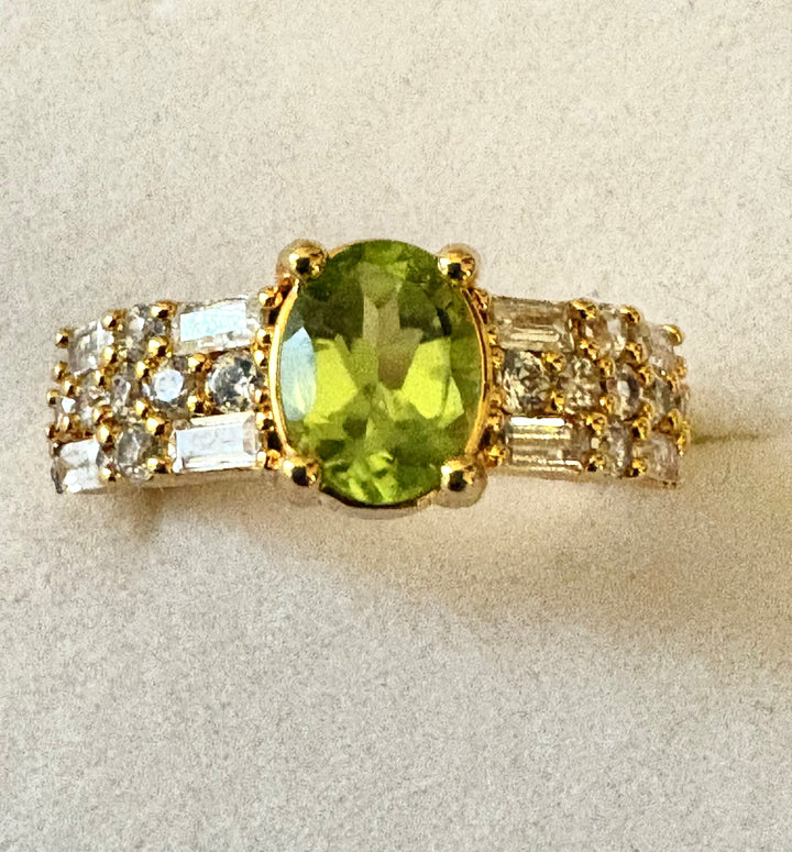 Niz & Aly natural apple green peridot ring with gold plating and sparkling AAA cubic zirconia baguette accents