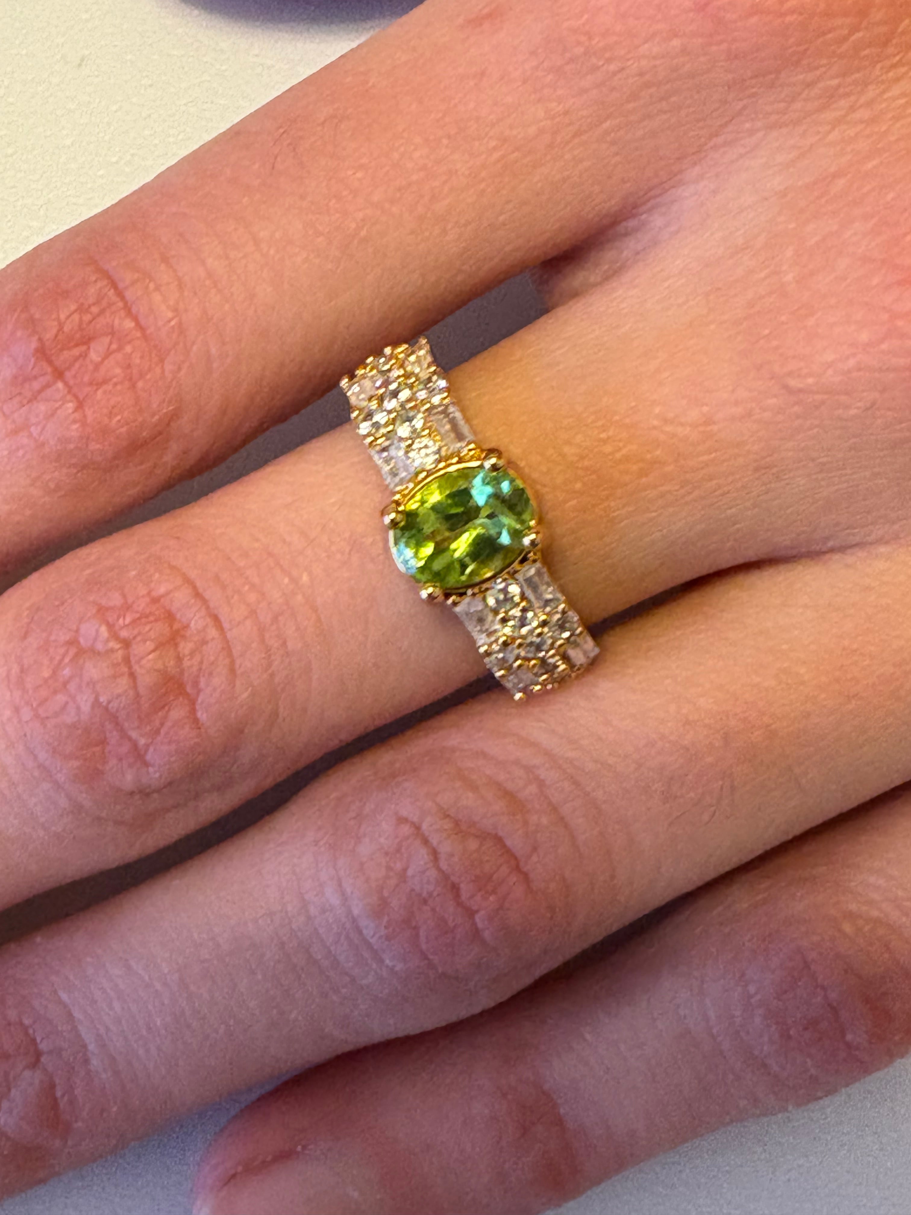 Niz & Aly adjustable gold-plated ring featuring a vibrant oval natural peridot and sparkling AAA cubic zirconia stones.