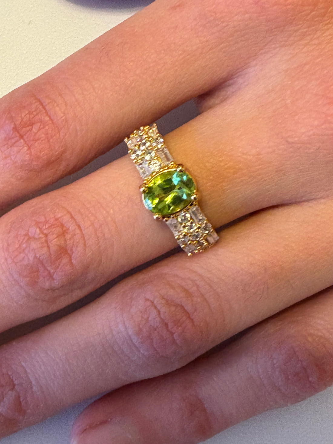 Niz & Aly adjustable gold-plated ring featuring a vibrant oval natural peridot and sparkling AAA cubic zirconia stones.