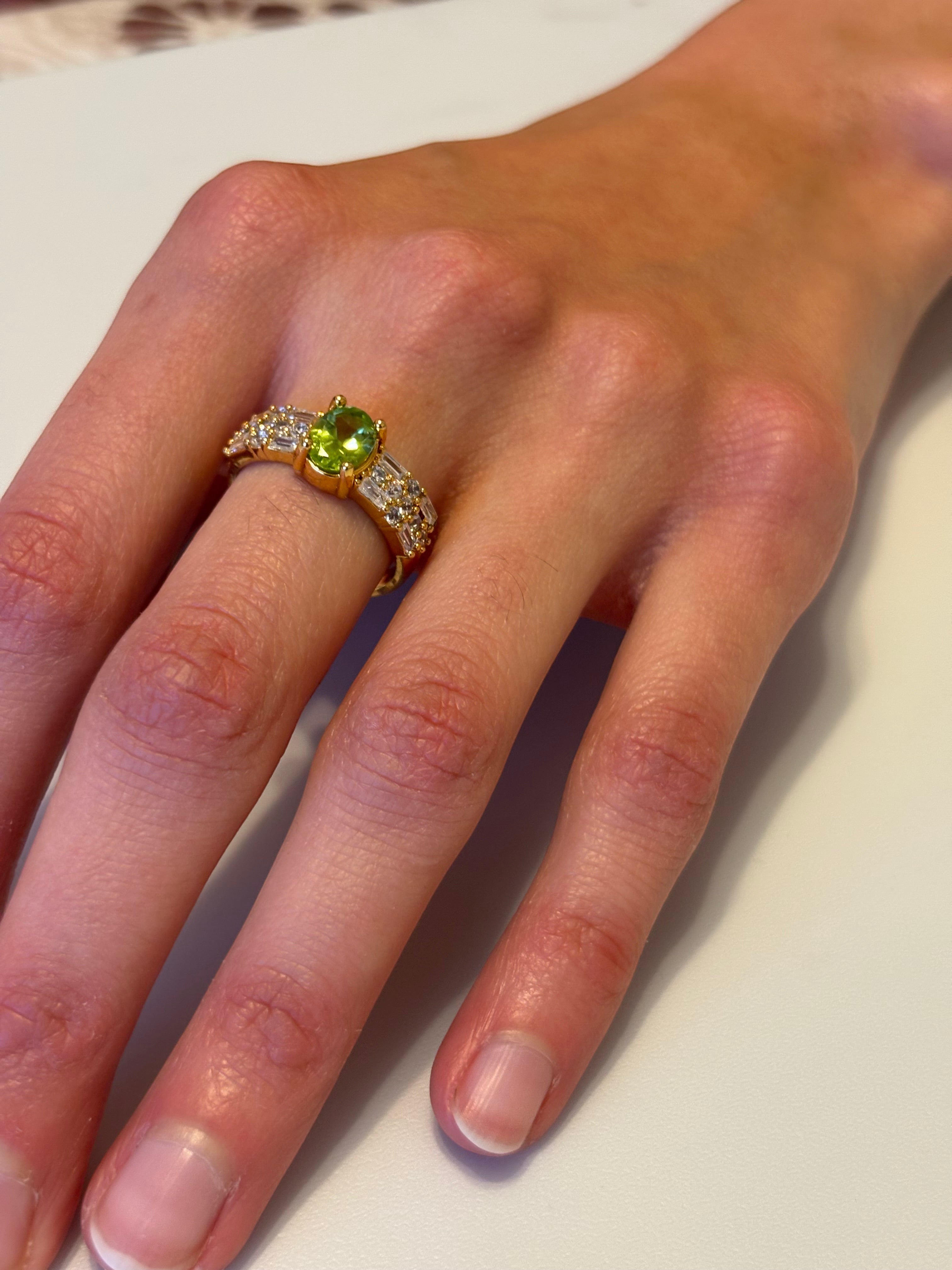 Niz & Aly adjustable gold-plated ring featuring a vibrant green peridot gemstone and sparkling cubic zirconia accents.