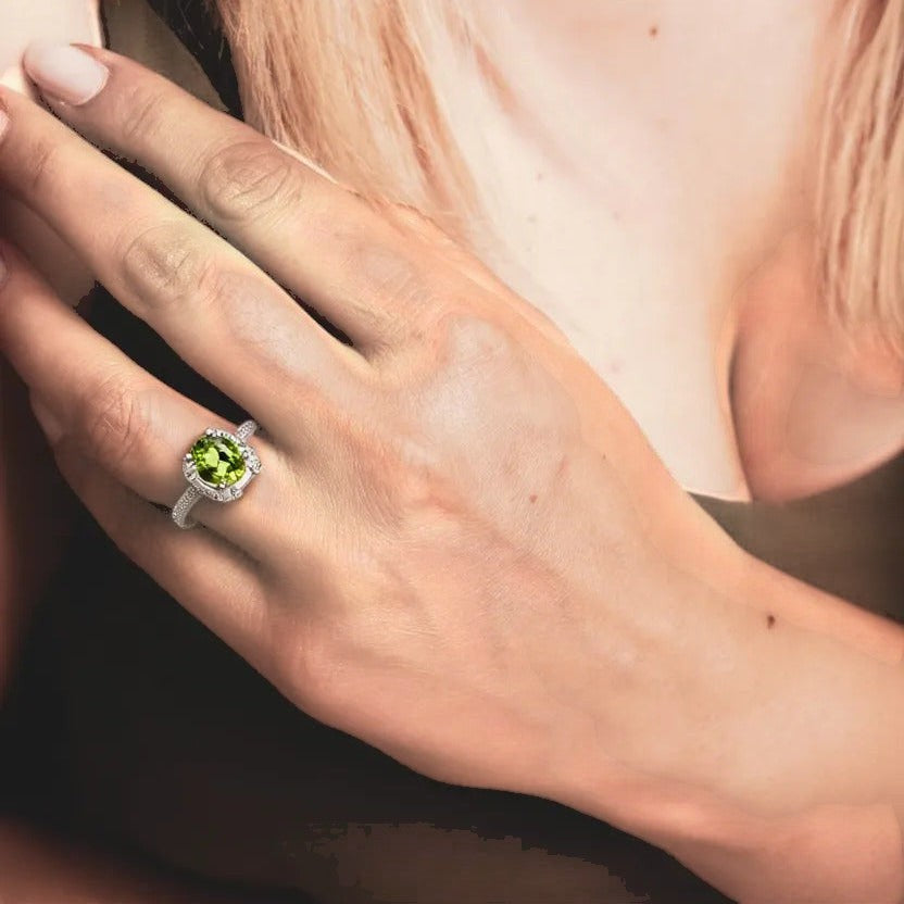 Niz & Aly Olive Bloom adjustable ring featuring a vibrant olive-green peridot gemstone on a delicate silver band.