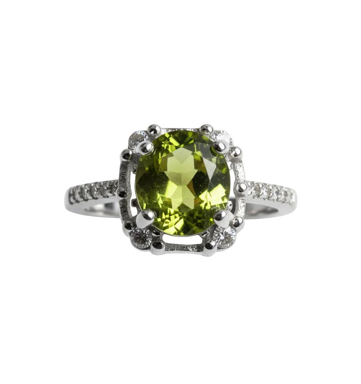 Niz & Aly Olive Bloom adjustable ring featuring an oval olive-green peridot gemstone set in a silver band.