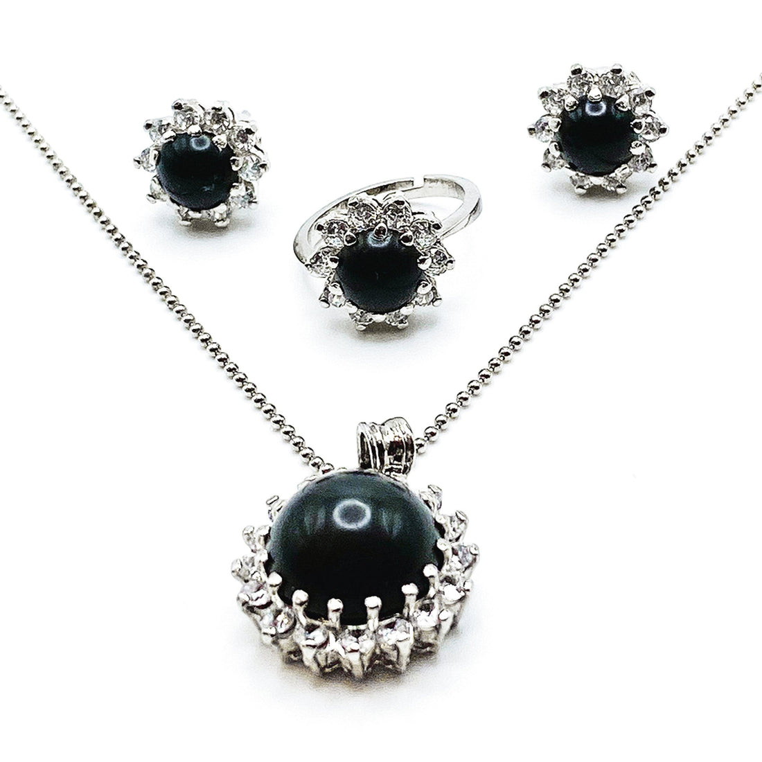 Niz & Aly Onyx Noir locket set featuring a black onyx pendant, matching stud earrings, and a ring with crystal halos.