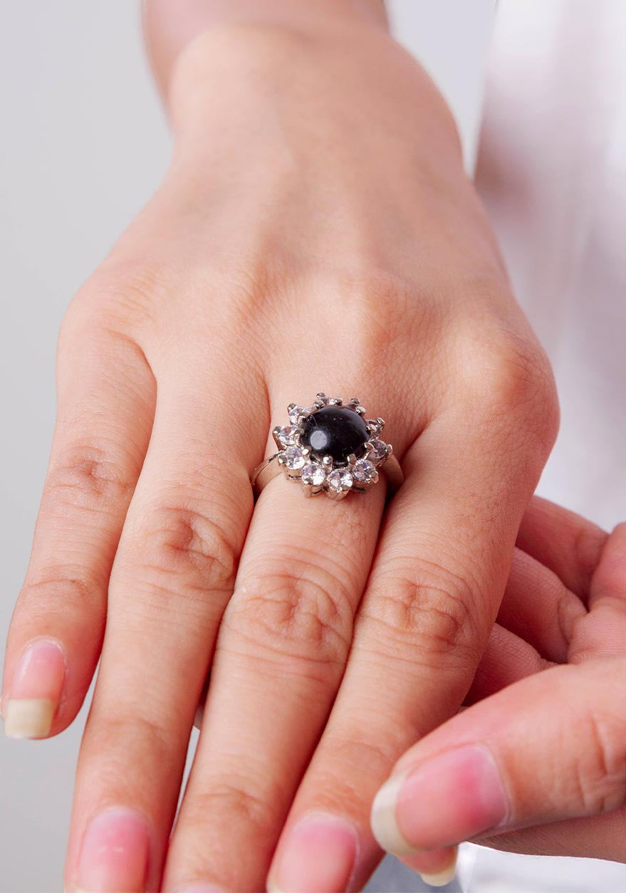 Niz & Aly Onyx Noir ring featuring a polished black onyx stone surrounded by a halo of sparkling clear crystals