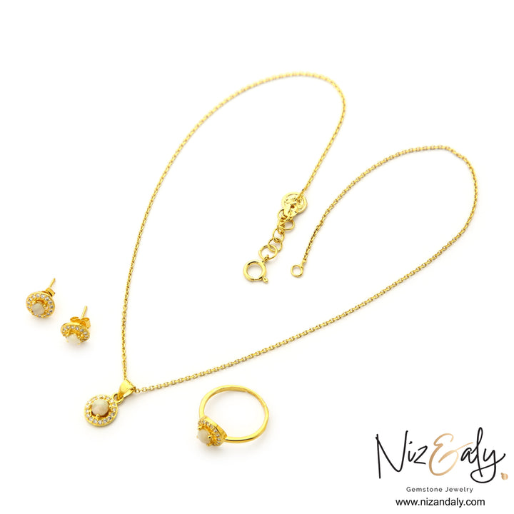 Niz & Aly dainty jewelry set featuring round Australian opal pendant necklace, stud earrings, and ring with halo stones.