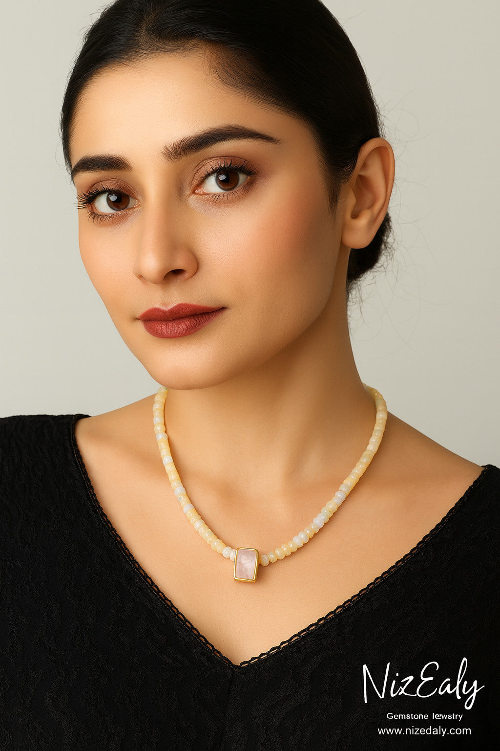 Niz & Aly Celestial Veil necklace featuring fire opal beads and a rectangular rainbow moonstone pendant on a model.
