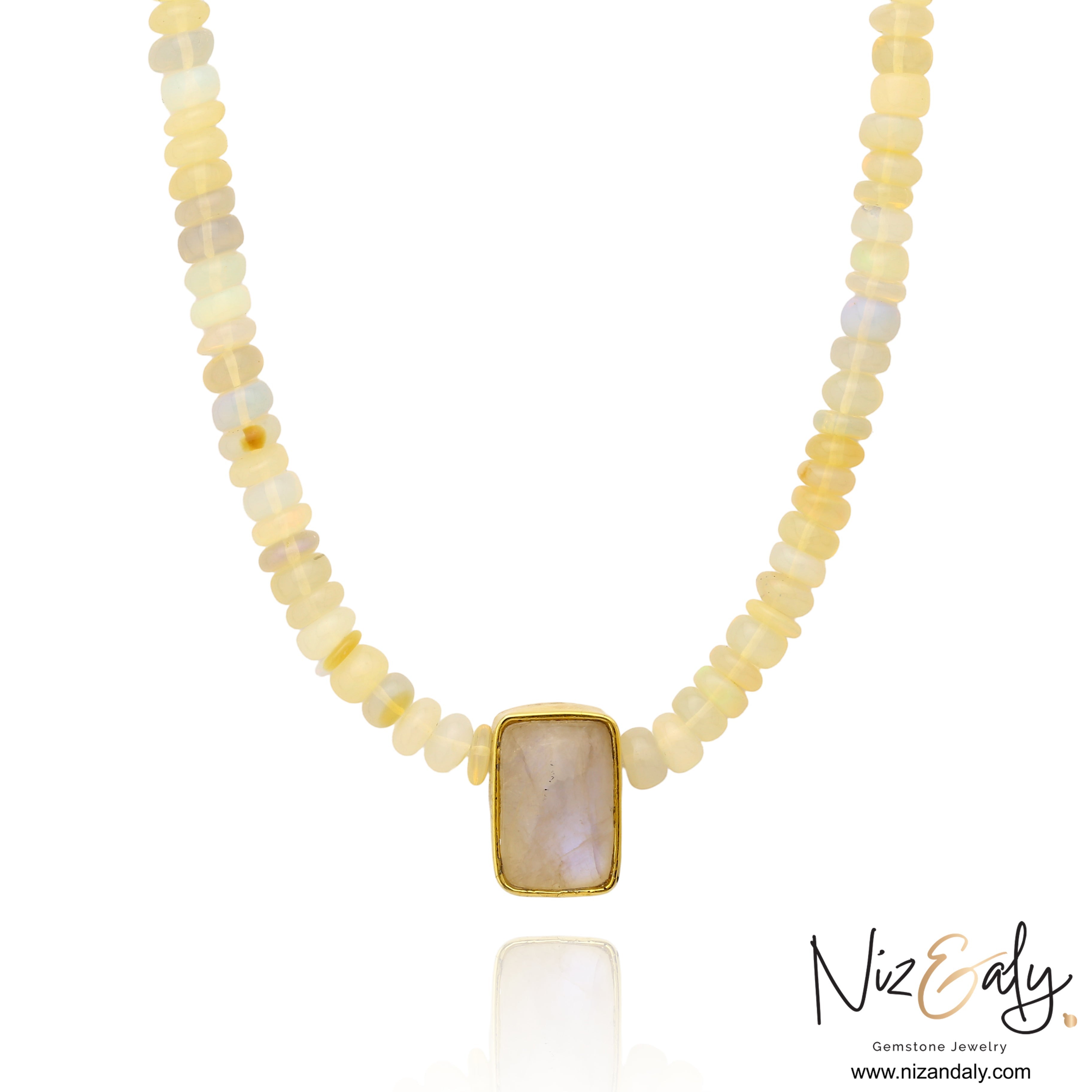 Niz & Aly Celestial Veil necklace featuring fire opal beads and a rectangular rainbow moonstone pendant in gold.