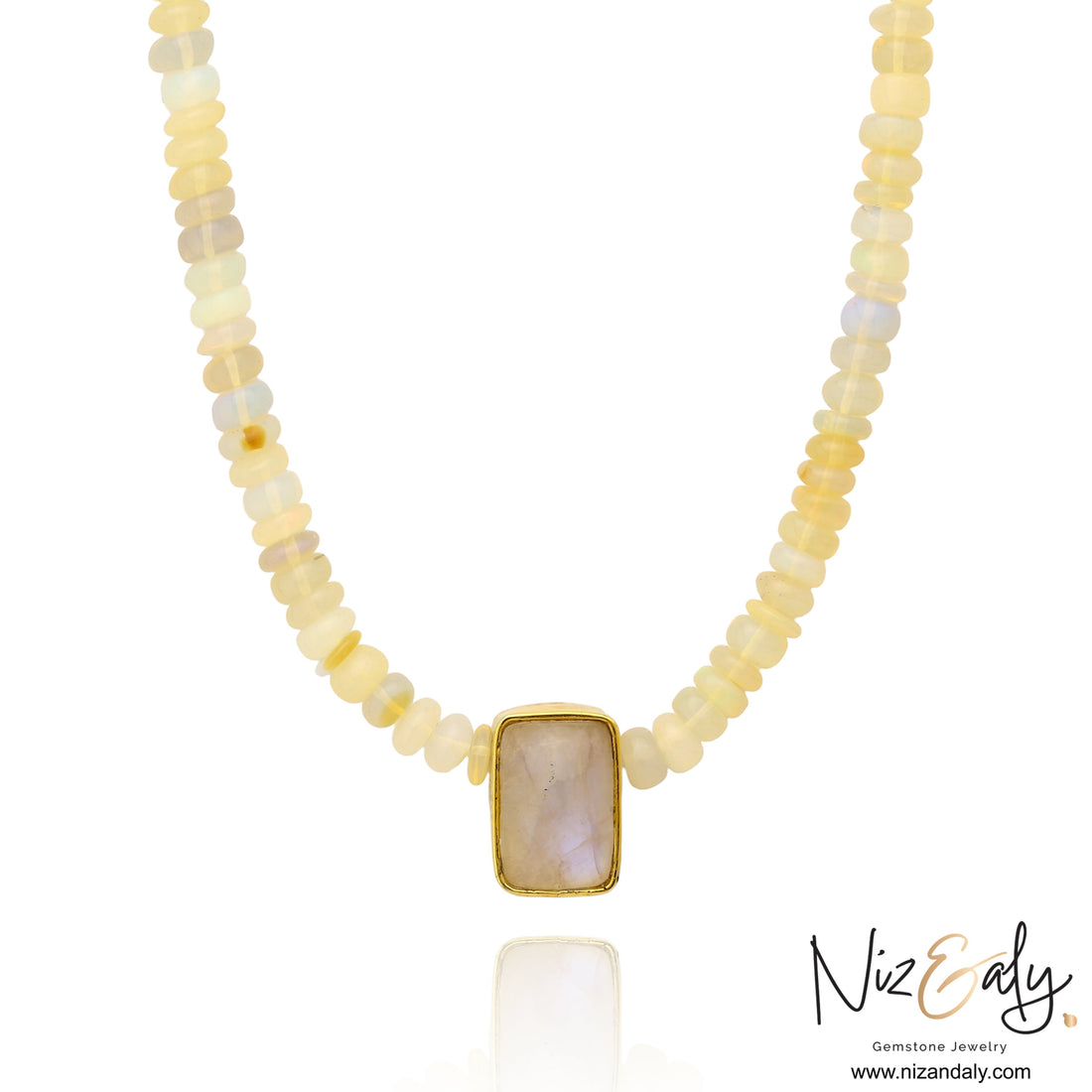 Niz & Aly Celestial Veil necklace featuring fire opal beads and a rectangular rainbow moonstone pendant in gold.