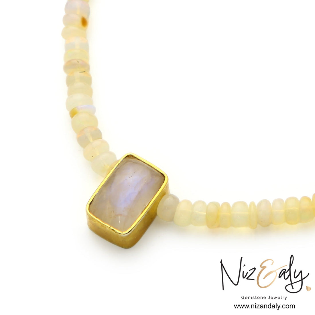 Niz & Aly Celestial Veil necklace featuring fire opal beads and a rectangular rainbow moonstone in a gold bezel setting