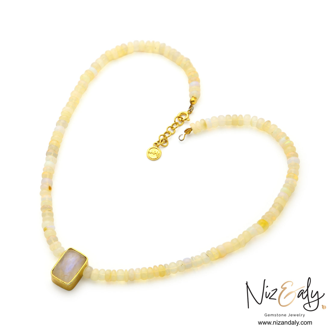 Niz & Aly Celestial Veil necklace featuring fire opal beads and a rectangular rainbow moonstone pendant in gold.