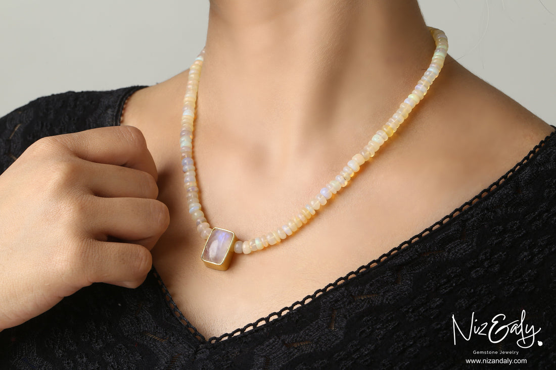 Niz & Aly Celestial Veil necklace featuring fire opal beads and a rectangular rainbow moonstone pendant in gold