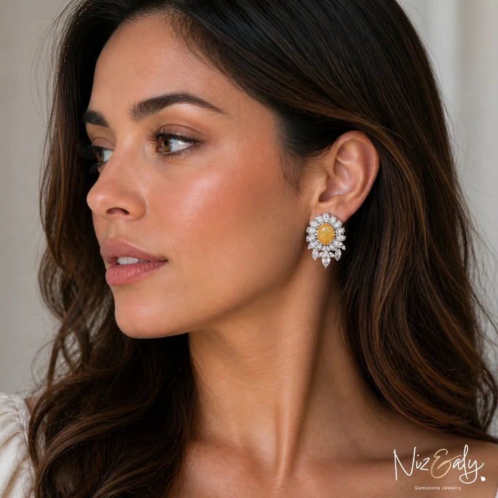 Niz & Aly natural opal and clear quartz stud earrings worn by a woman, featuring a floral crystal design.