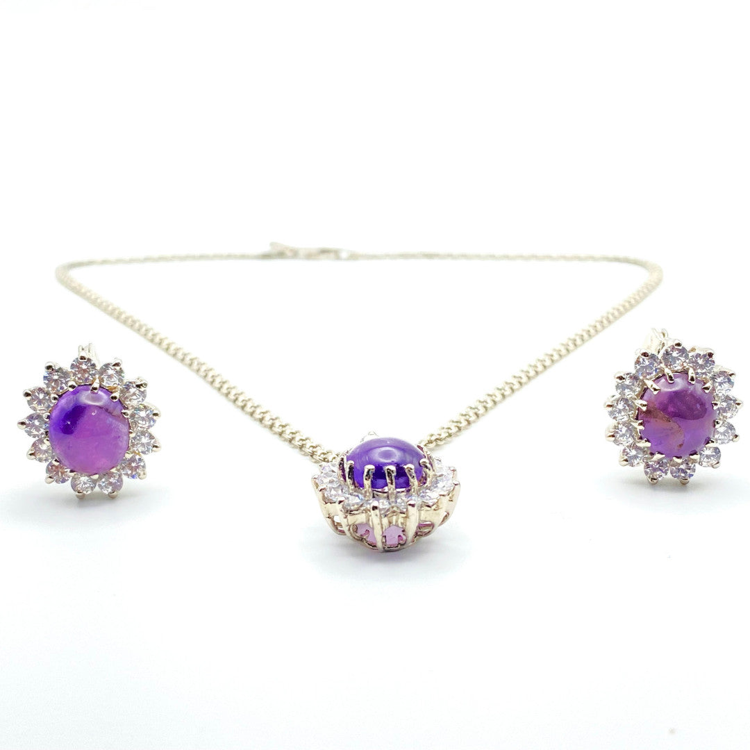 Niz & Aly oval cabochon amethyst jewelry set with purple gemstones surrounded by sparkling clear crystals on silver