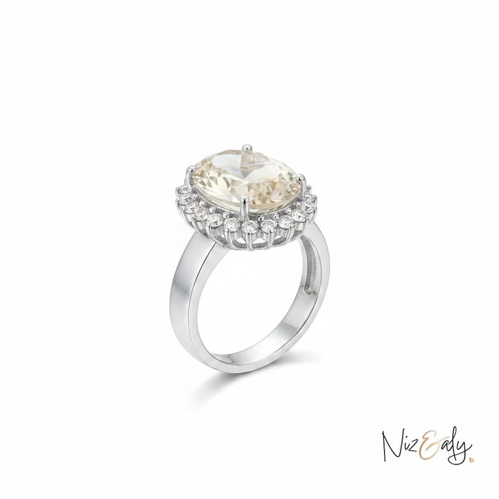 Niz & Aly oval citrine ring with a halo of sparkling diamonds set in polished silver for an elegant look.