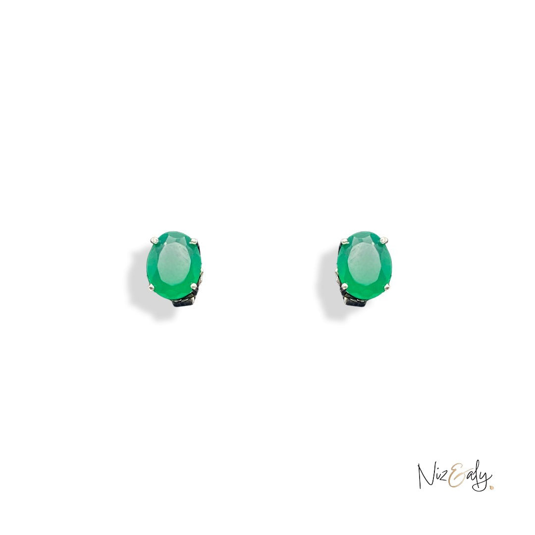 Niz & Aly dainty oval emerald stud earrings featuring vibrant green natural gemstones in a minimalist metal setting.