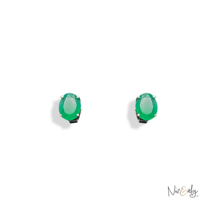 Niz & Aly dainty oval emerald stud earrings featuring vibrant green natural gemstones in a minimalist metal setting.