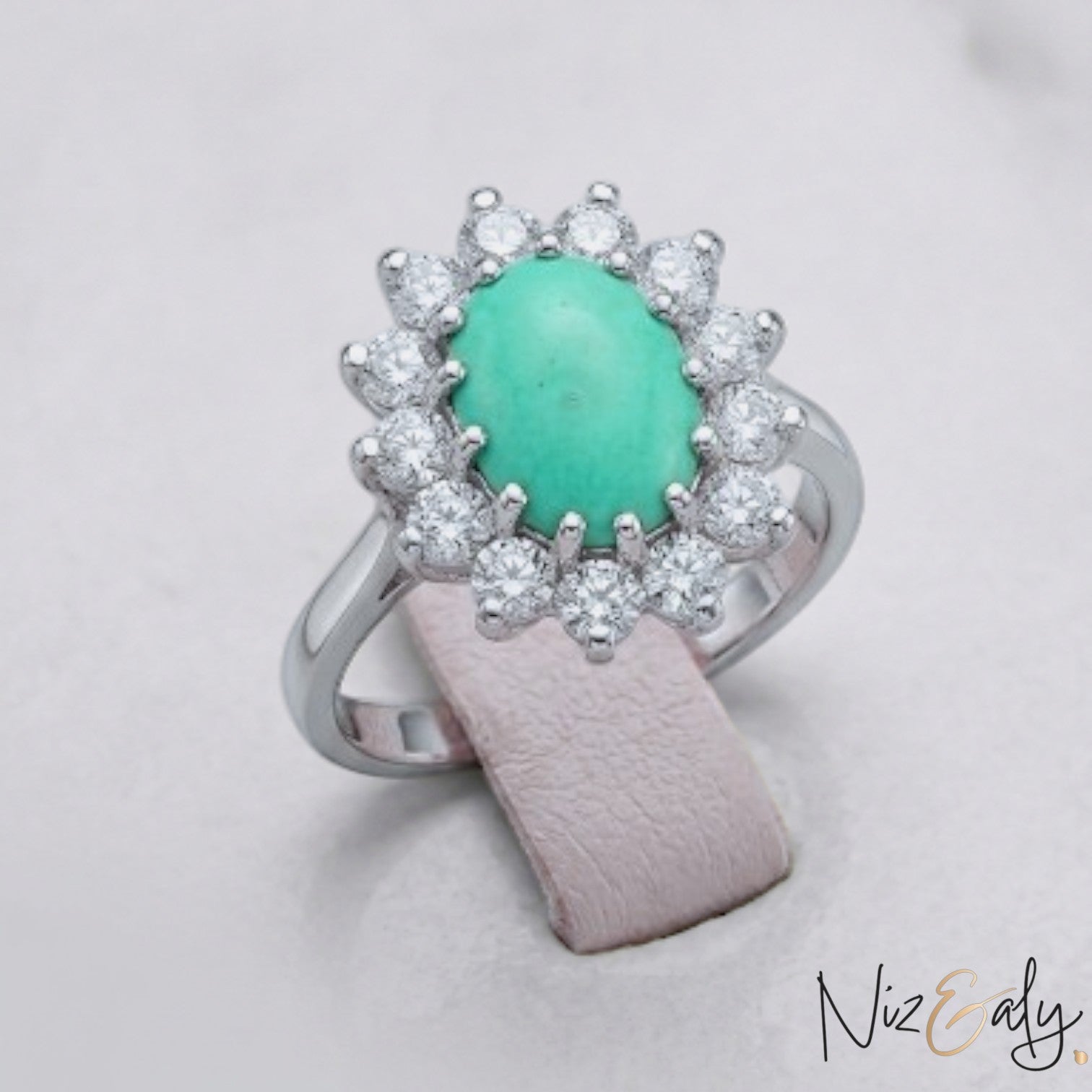 Niz & Aly oval Persian turquoise ring with a halo of sparkling white diamonds set in polished silver