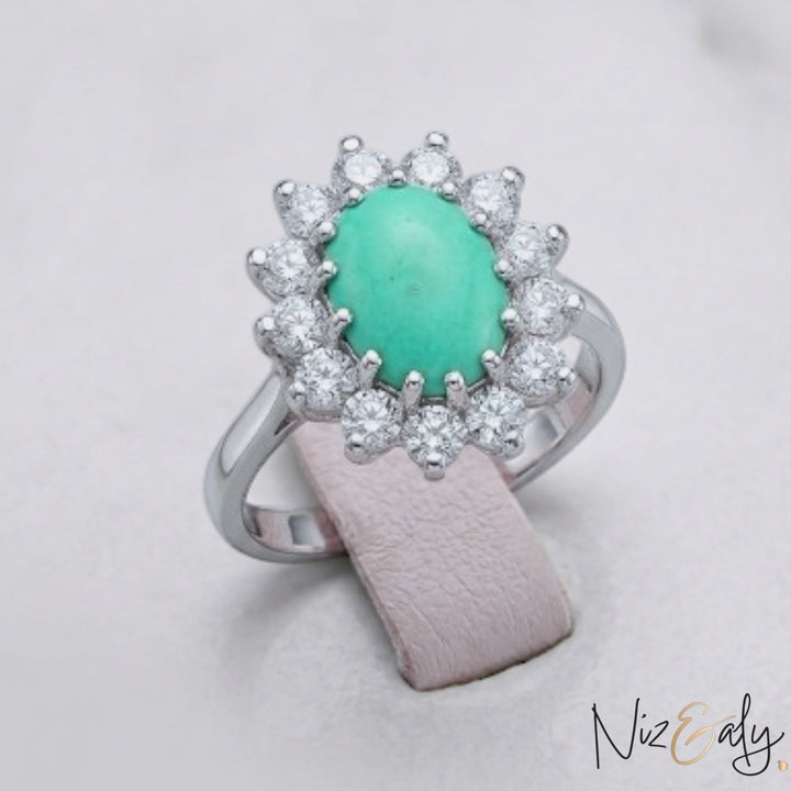 Niz & Aly oval Persian turquoise ring with a halo of sparkling white diamonds set in polished silver