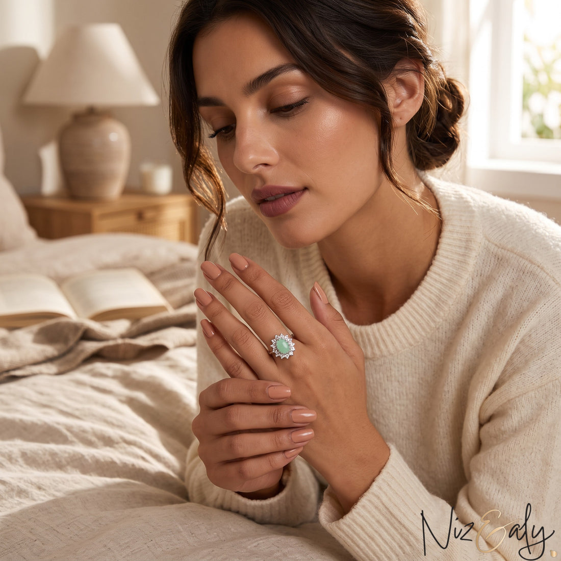 Niz & Aly oval Persian turquoise ring with a halo setting worn by a woman in a cozy bedroom setting.