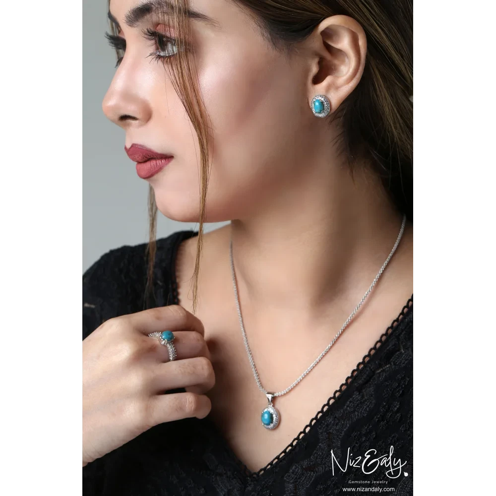 Niz & Aly oval turquoise gemstone necklace, stud earrings, and ring set with cubic zirconia halo in silver-tone