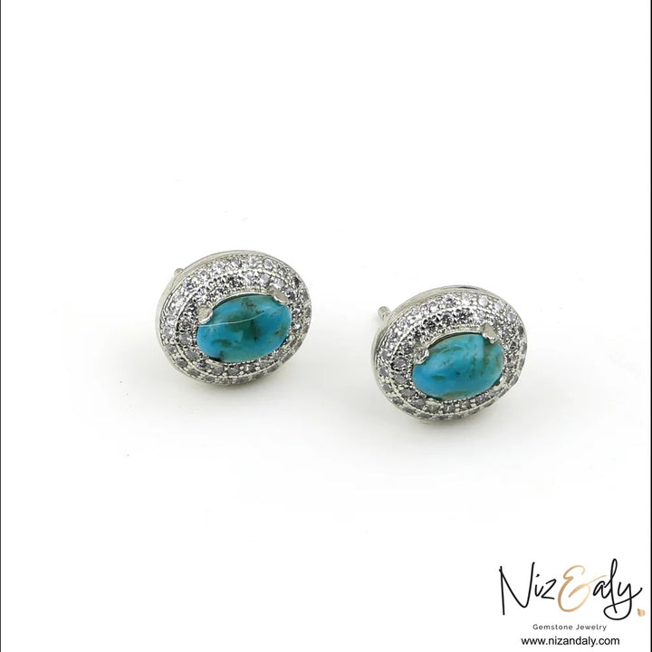 Niz & Aly oval turquoise stud earrings with a sparkling white cubic zirconia halo in a polished silver-toned setting