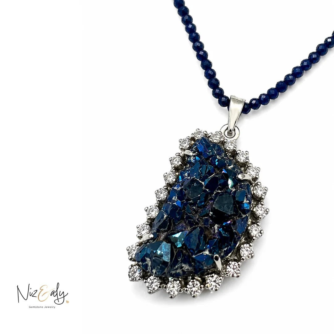Niz & Aly peacock ore bornite pendant necklace with faceted blue lapis lazuli beads and a sparkling crystal halo.