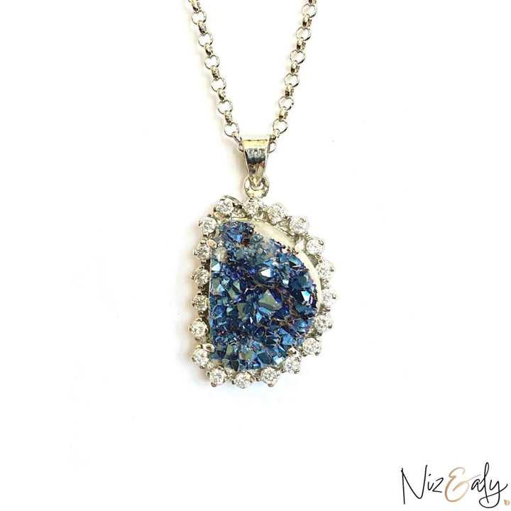 Niz & Aly peacock ore bornite pendant with iridescent blue crystals in a sterling silver halo setting on a chain