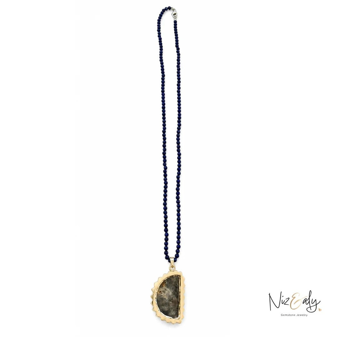 Niz & Aly peacock ore bornite pendant on a strand of deep blue faceted lapis lazuli beads with gold-tone setting