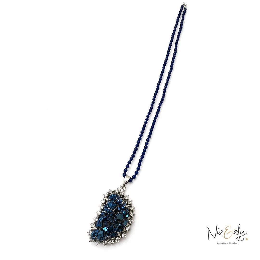 Niz & Aly peacock ore bornite pendant necklace with faceted blue lapis lazuli beads and shimmering iridescent stone