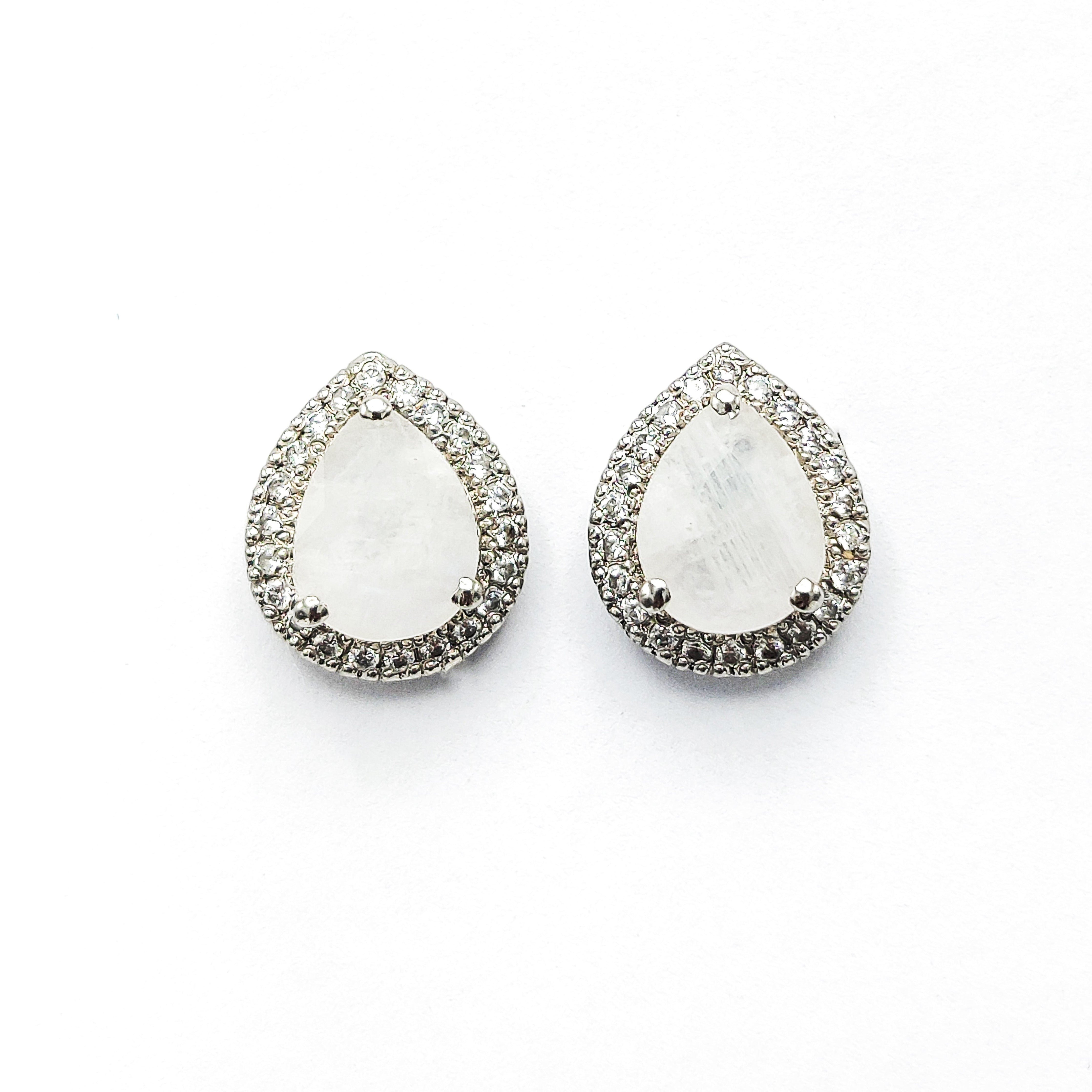 Niz & Aly pear-shaped moonstone stud earrings with a halo of sparkling crystals in a silver-tone setting.