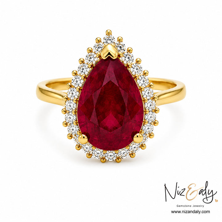 Niz & Aly pear-cut natural ruby ring with a diamond halo set in polished yellow gold