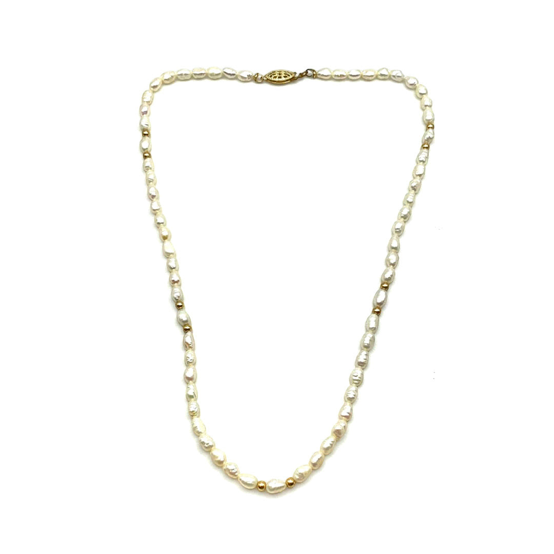 Niz & Aly Pearl Harvest necklace featuring rice-shaped ivory freshwater pearls and 14 carat gold accents.