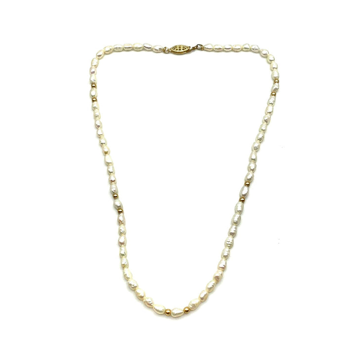Niz & Aly Pearl Harvest necklace featuring rice-shaped ivory freshwater pearls and 14 carat gold accents.