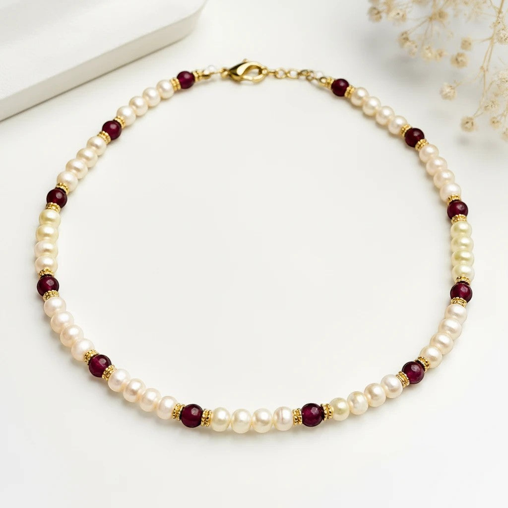 Niz & Aly Pearl Harmony necklace featuring lustrous freshwater pearls, red agate beads, and gold spacers on white.