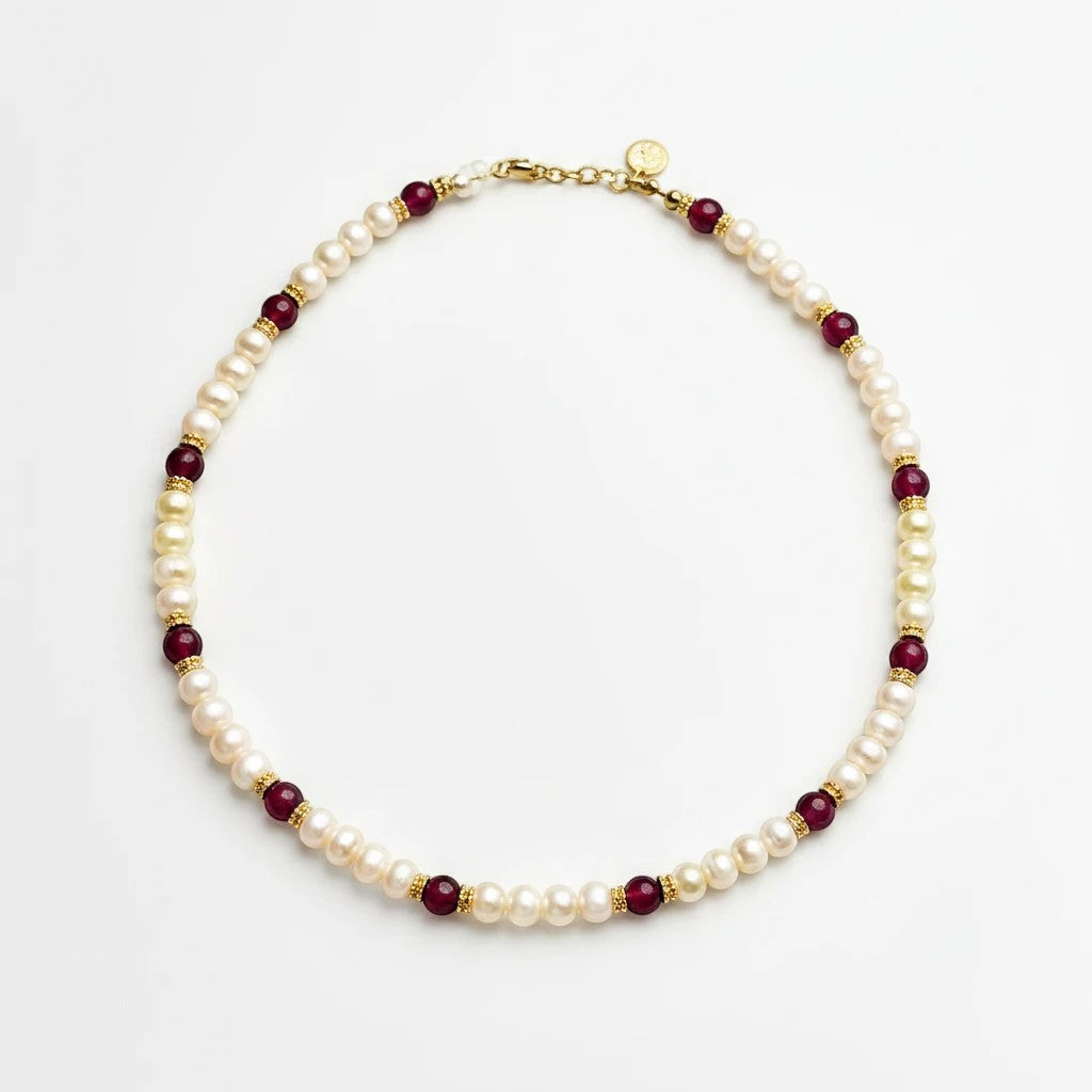 Niz & Aly Pearl Harmony necklace featuring freshwater pearls, red agate beads, and gold spacers on a white background.