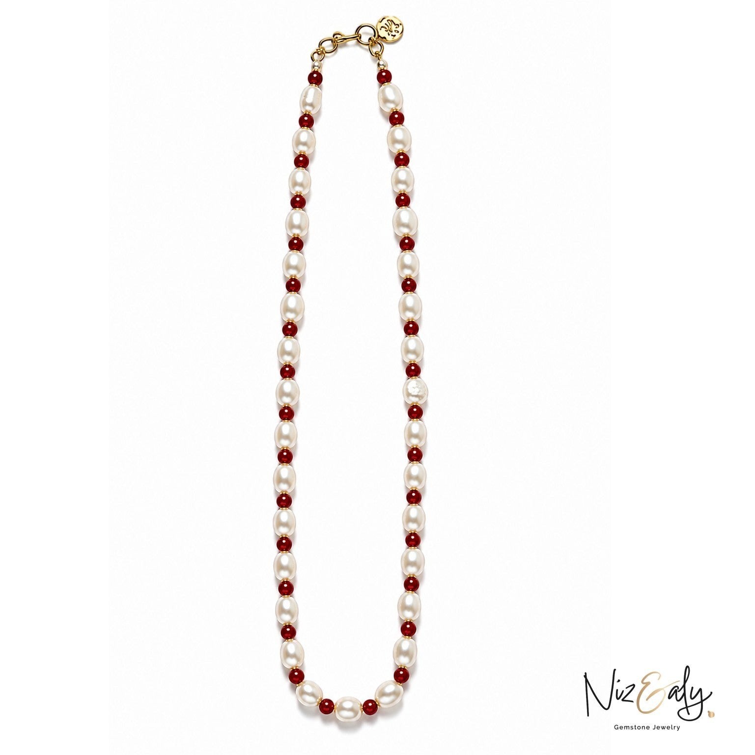 Niz & Aly necklace featuring alternating white freshwater pearls and small red gemstone beads with a gold clasp.
